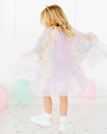 Girl twirling wearing pastel cape