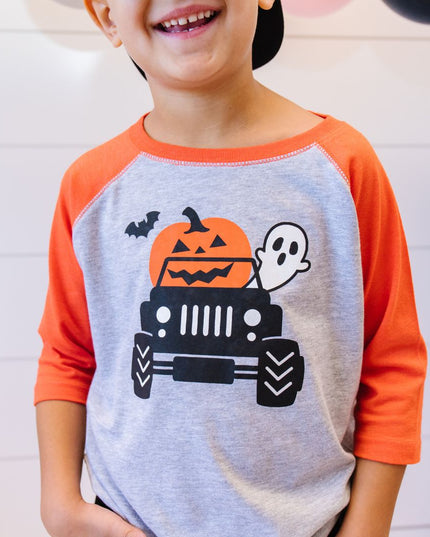 Boy wearing Halloween T-shirt with truck, pumpkin, ghost and bat graphic