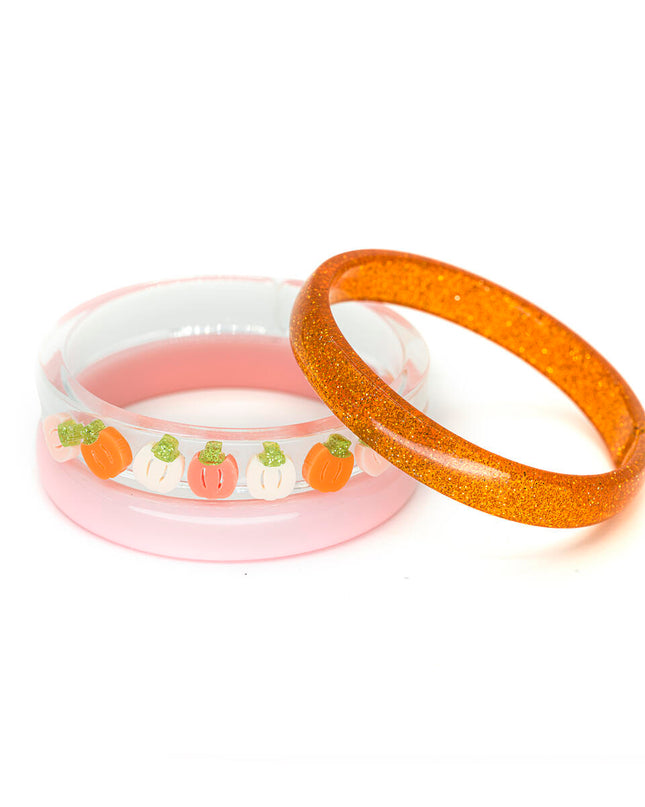 Bangle set featuring an orange glitter bangle, pink bangle and clear bangle with orange, cream and pink colored pumpkins