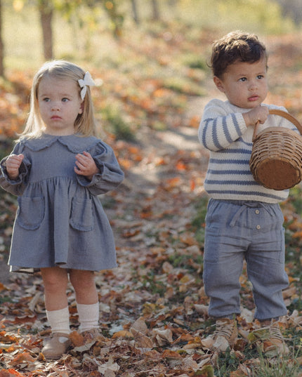 Two young children wearing fall clothing