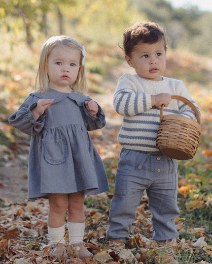 Two young children wearing fall clothing