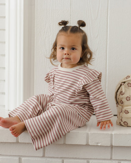 Little girl wearing mauve and white striped outfit