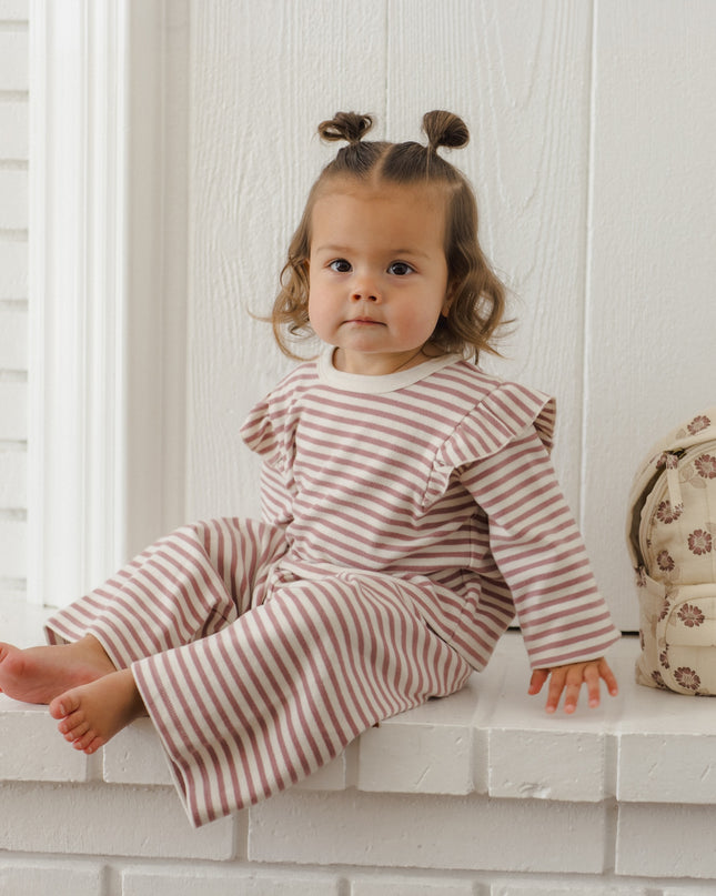 Little girl wearing mauve and white striped outfit