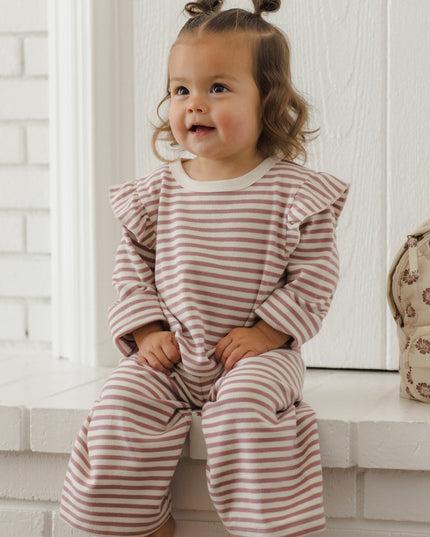 Little girl wearing mauve and white striped outfit
