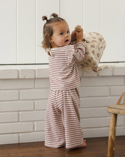 Little girl wearing mauve and white striped outfit