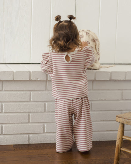 Little girl wearing mauve and white striped outfit
