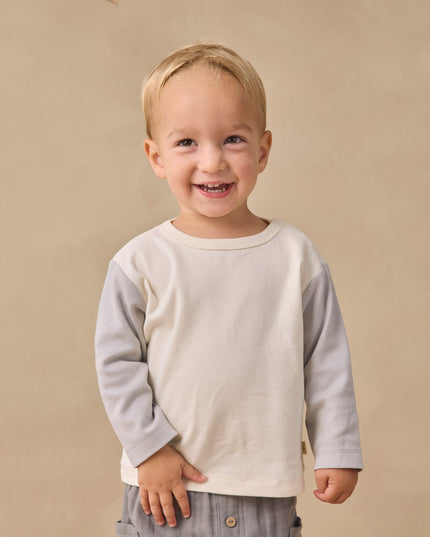 Boy wearing Long sleeve children's white raglan tee with grey sleeves and grey pants