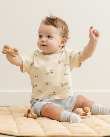 Baby wearing car shirt and light blue shorts
