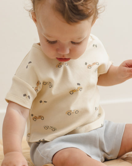 Baby wearing car shirt and light blue shorts