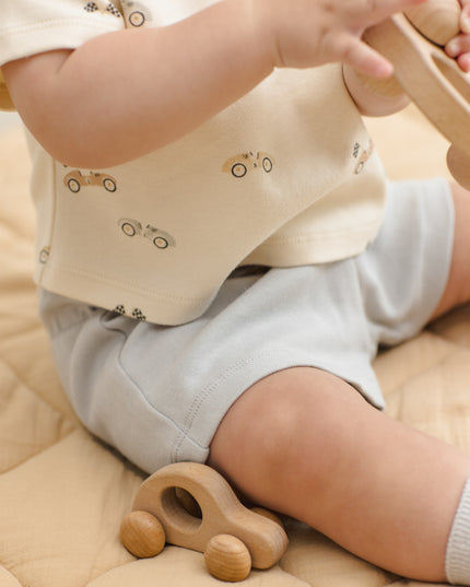 Baby wearing car shirt and light blue shorts
