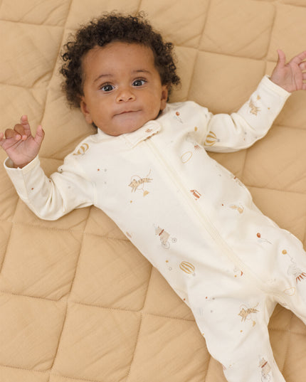 Baby wearing Longsleeve footie pajamas with a carnival print