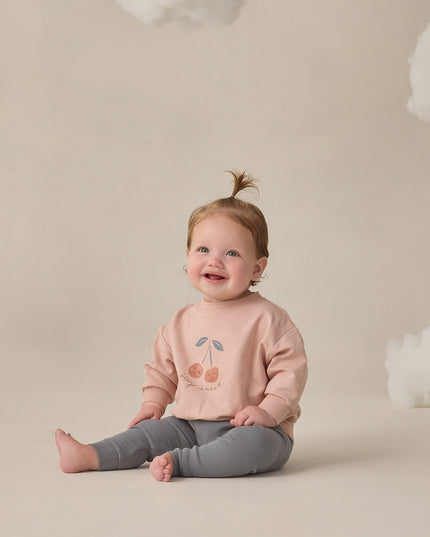 Baby wearing Blush sweatshirt with 'stay sweet' cherry graphic