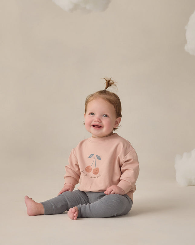 Baby wearing Blush sweatshirt with 'stay sweet' cherry graphic