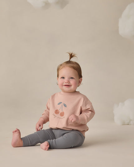 Baby wearing Blush sweatshirt with 'stay sweet' cherry graphic