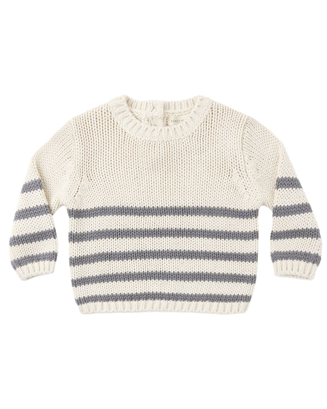 A cream-colored knit sweater with horizontal gray stripes across the lower half and on the sleeves