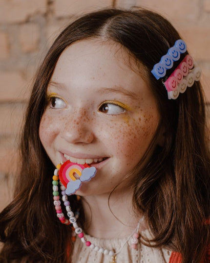 Girl wearing "Happy" Rainbow Necklace