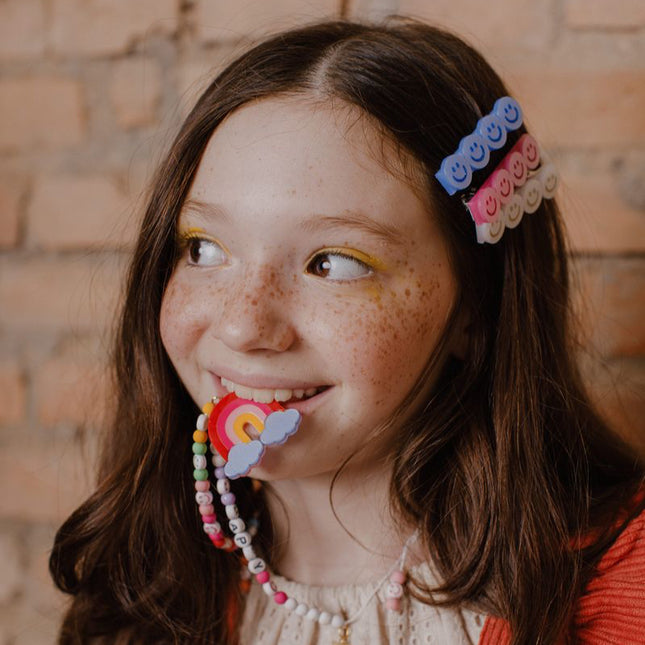 Girl wearing "Happy" Rainbow Necklace