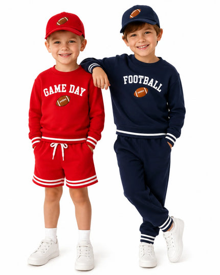 Two boys wearing red and blue football outfits