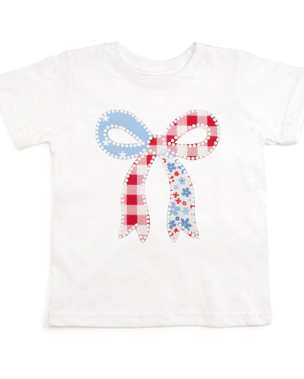 White t-shirt with a patchwork bow design featuring red, white, and blue colors