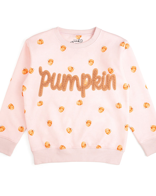 Pink crewneck sweatshirt with pumpkin pattern and patch that reads 'pumpkin'