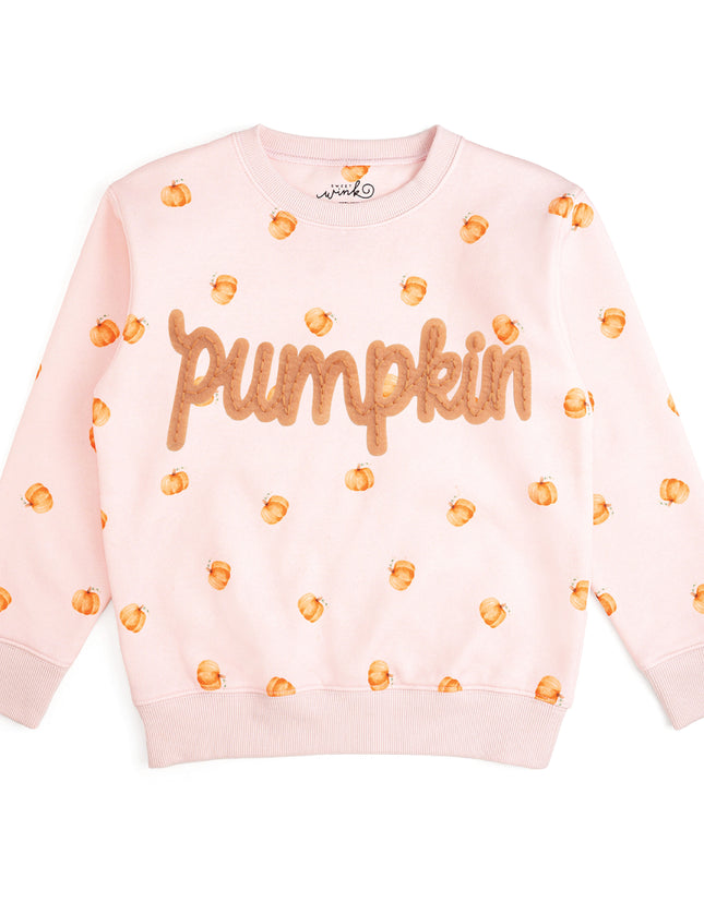 Pink crewneck sweatshirt with pumpkin pattern and patch that reads 'pumpkin'