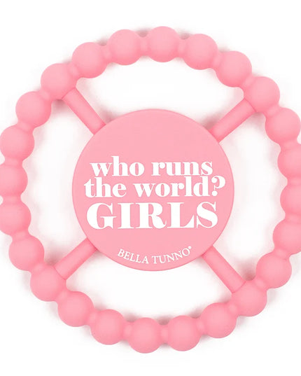 A pink silicone baby teether with the text 'who runs the world? GIRLS' 