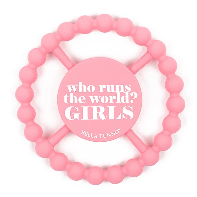 A pink silicone baby teether with the text 'who runs the world? GIRLS' 