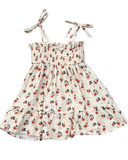 White tiered dress with floral print and tied sleeves