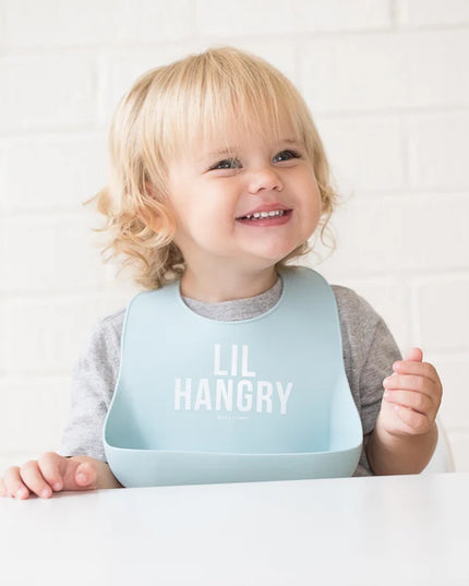 Baby wearing a light blue 'LIL HANGRY' bib