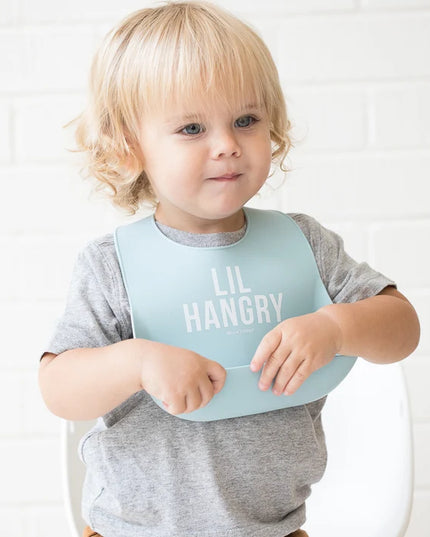 Baby wearing a light blue 'LIL HANGRY' bib