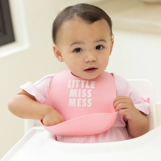 Baby wearing pink bib with 'Little Miss Mess' text 