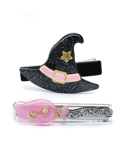 Two hair clips - one shaped like a black glittery witch hat and the other a silver and pink broom