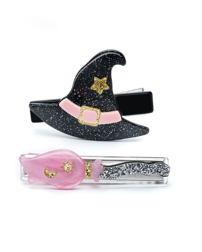 Two hair clips - one shaped like a black glittery witch hat and the other a silver and pink broom