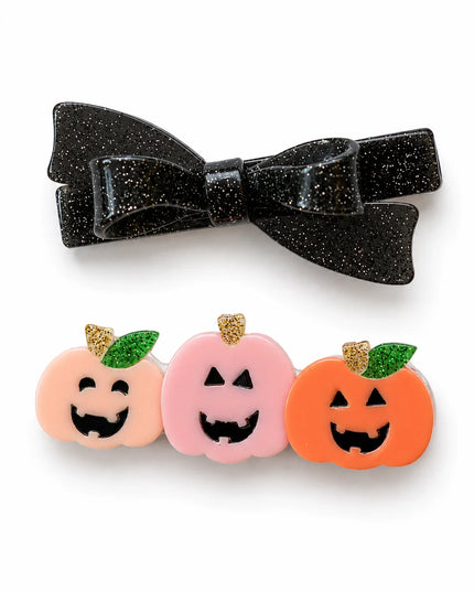 Two halloween themed hair clips - one a black glittery bow and the other a trio of jack-o-lantern pumpkins