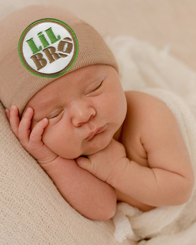 Baby wearing tan hat with lil bro football patch